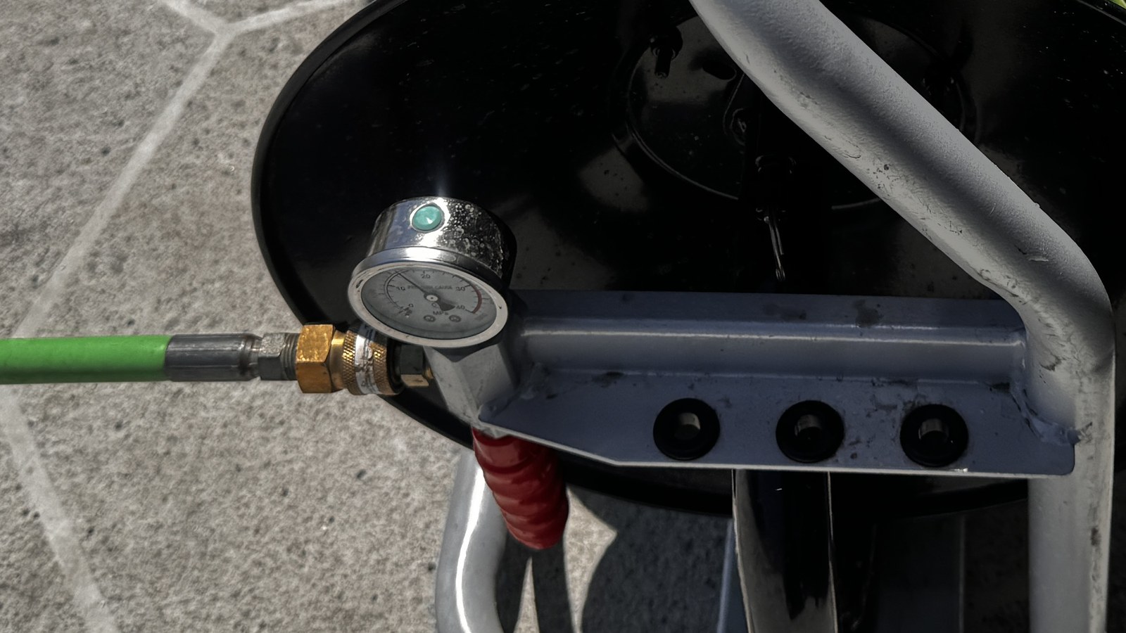 Pressure gauge on a hydro jetting hose reel during a residential sewer cleaning