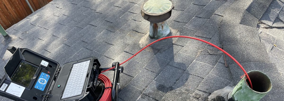 Sewer scope inspection camera setup at a residential roof vent access point