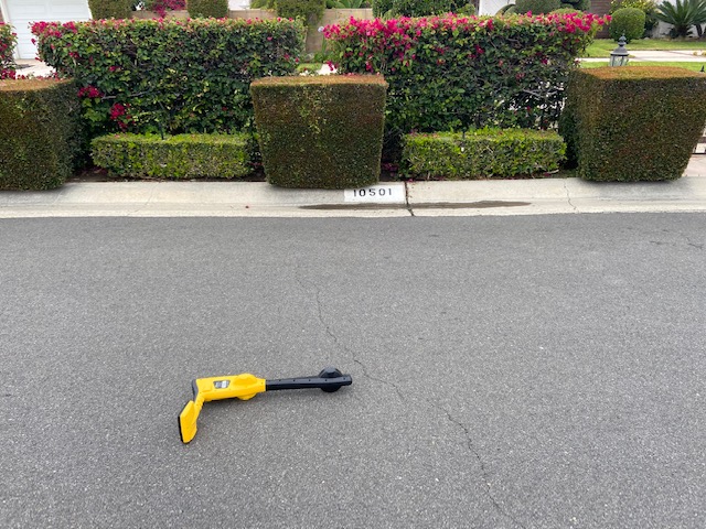 Sewer line locator laid in the street to mark the surface location of the city sewer tap