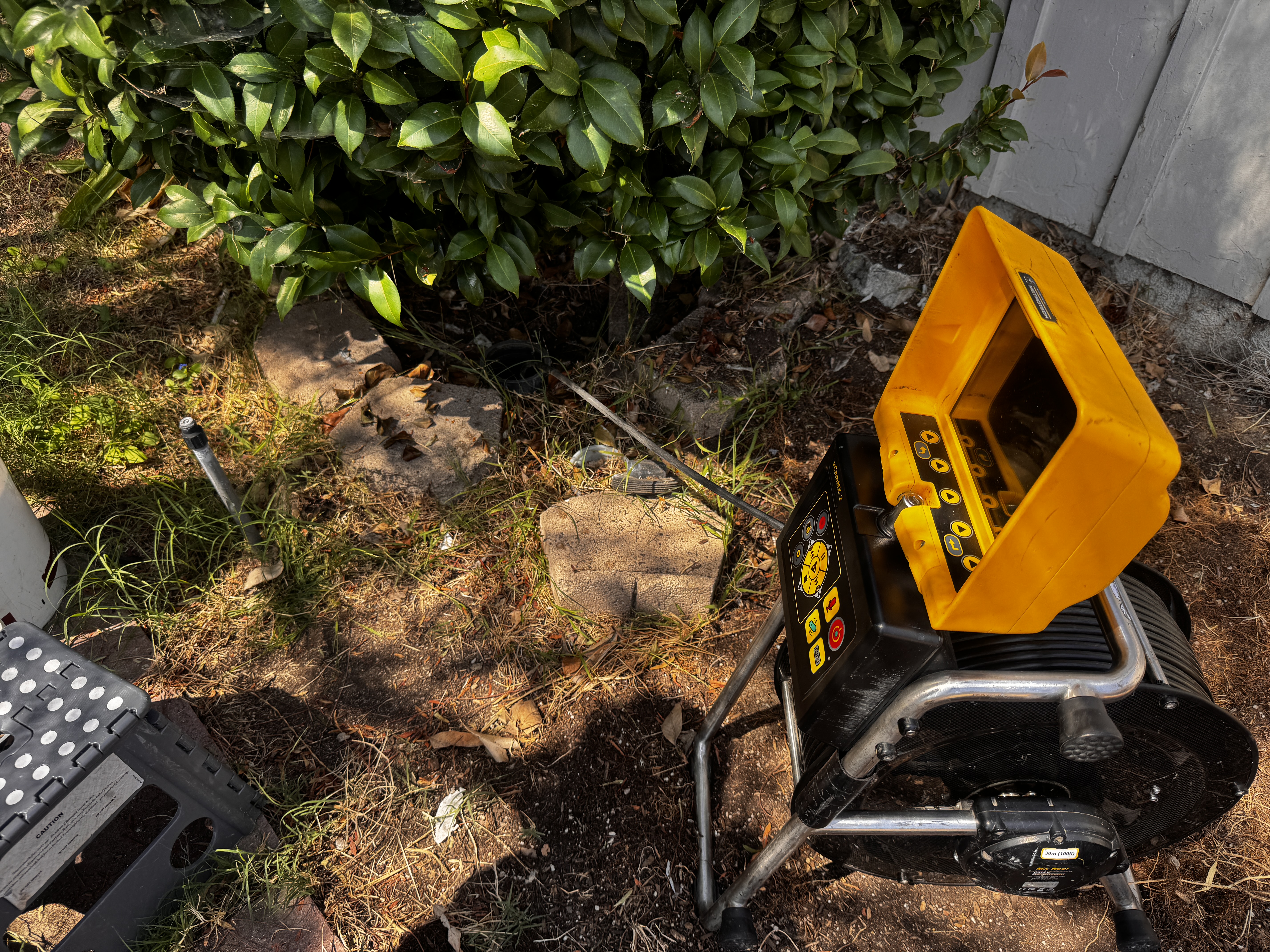 FlowProOC technician setting up sewer scope camera equipment at a cleanout access point in Placentia
